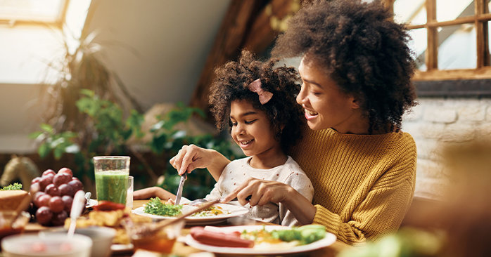 Mother and daughter eating healthy foods